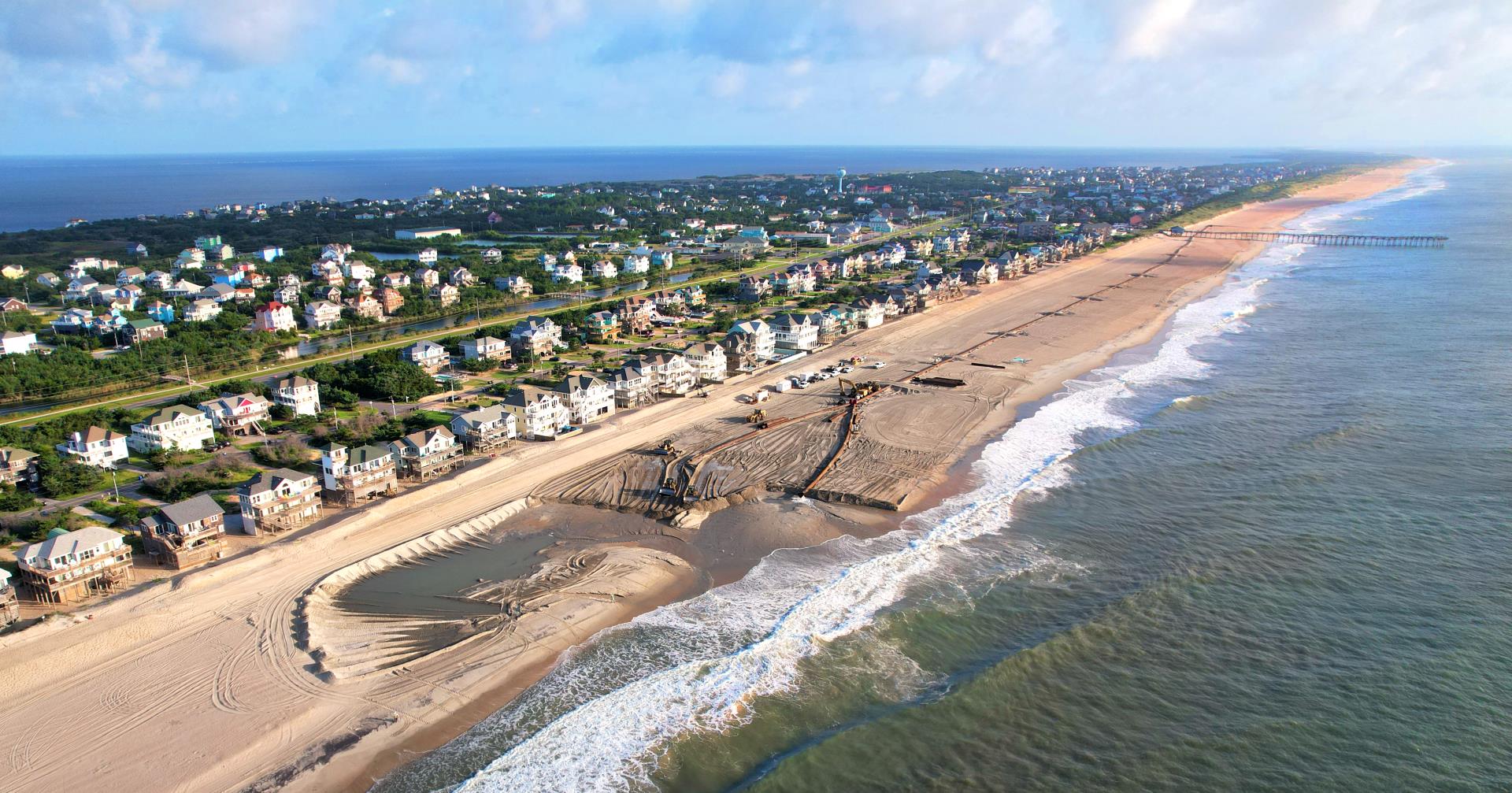 Aerial image of the Avon beach nourishment progress, nearing completion.