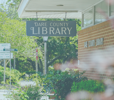Image of the Manteo library sign which reads, 