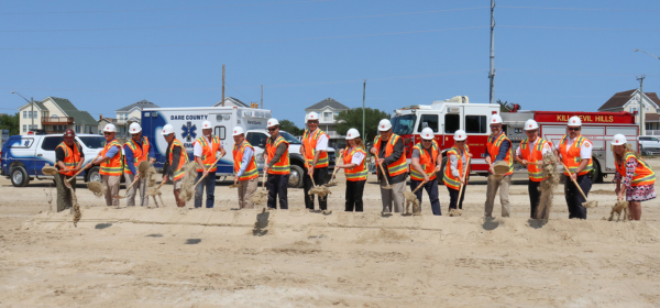 Image of a row of people digging sand for the EMS Station 1 Groundbreaking Ceremony.