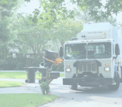 Image of a Dare County trash truck picking up a trash can