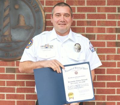Image of James Wilmoth holding his VFW Award.