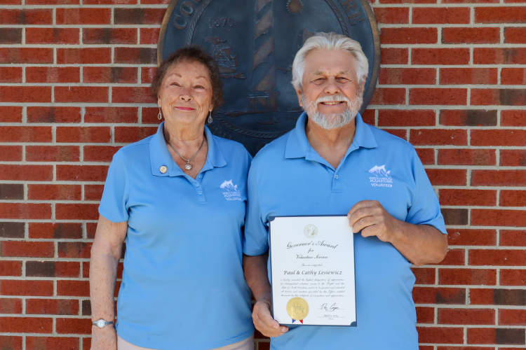 Image of Paul and Cathy Lesiewicz holding their certificate.